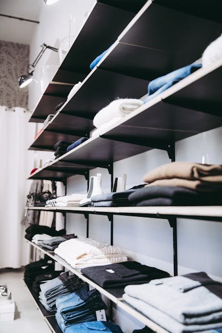 pexels-photo-1884579-1884579 Neatly organized shelves with folded clothes in a contemporary store setting.