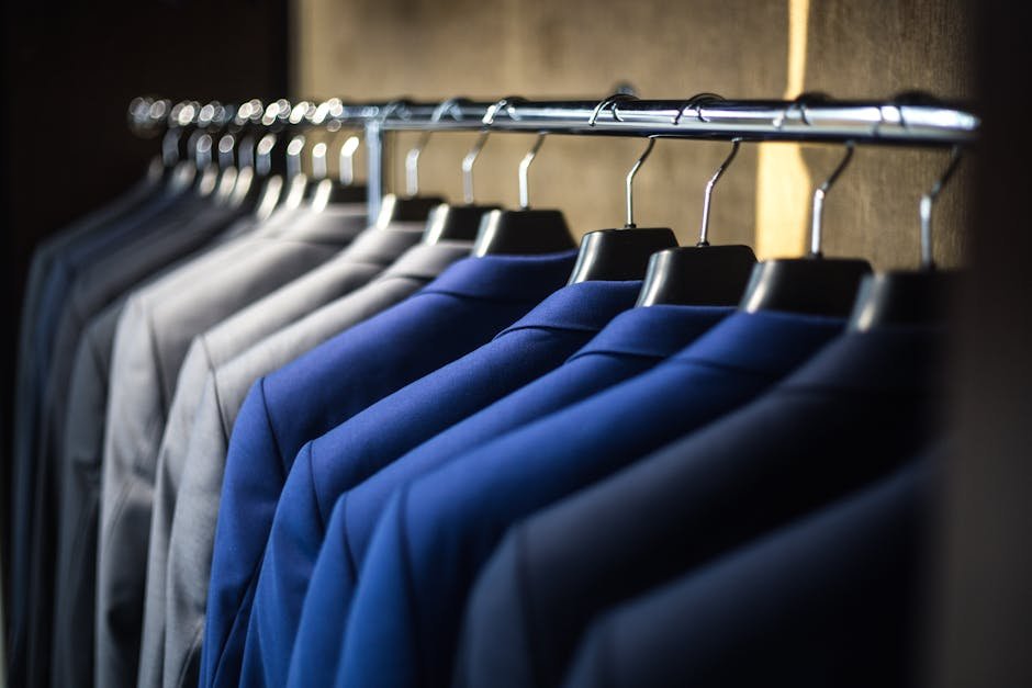 pexels-photo-325876-325876 Close-up of neatly arranged suits in a wardrobe, showcasing fashion and organization.