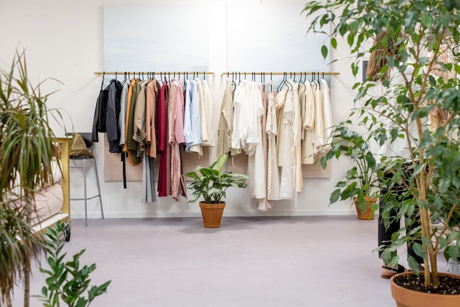 pexels-photo-3965545-3965545 Chic fashion boutique showcasing vibrant clothing collection with lush indoor plants.